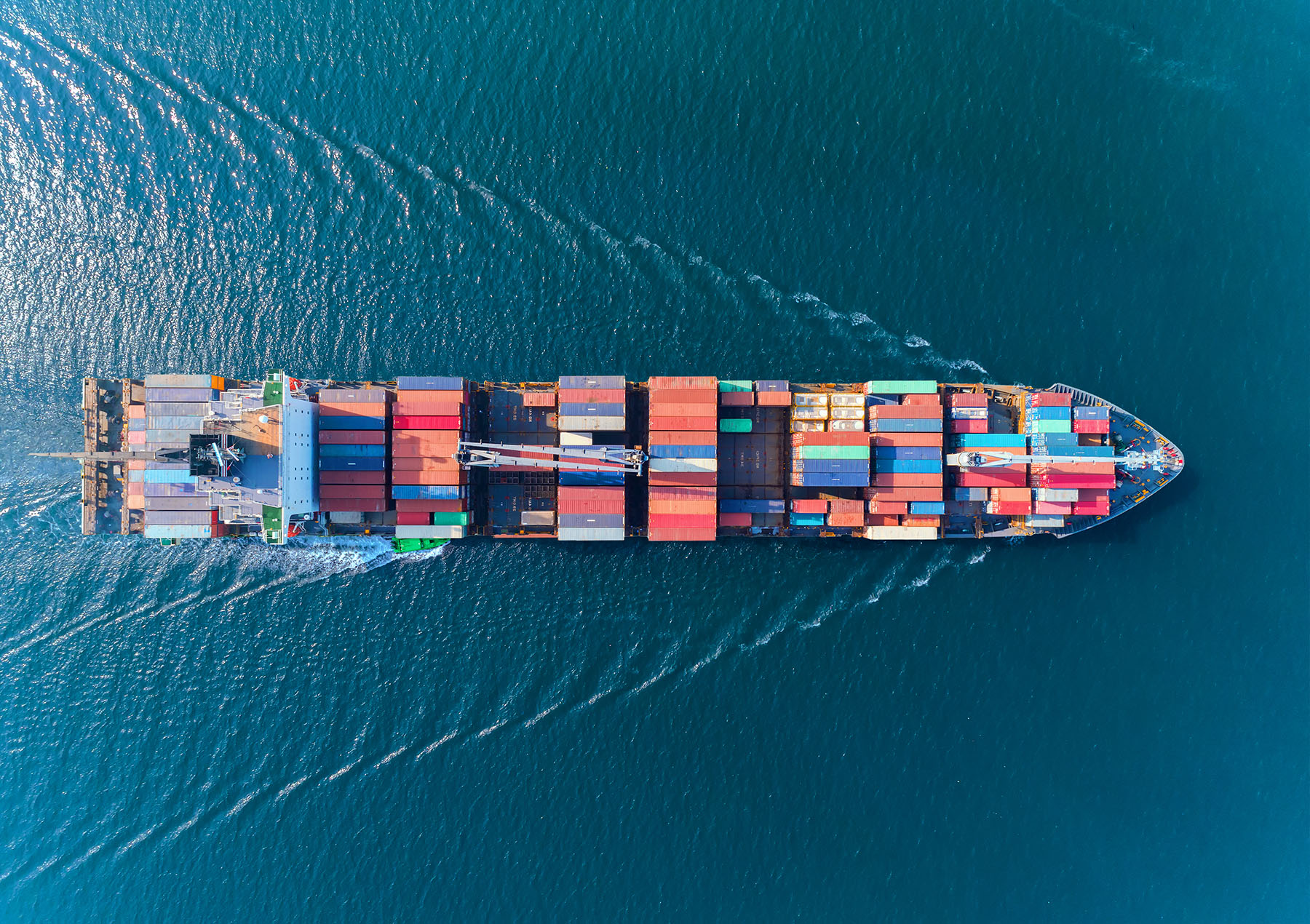 Aerial top view container ship with crane bridge for load container, logistics import export, shipping or transportation concept background.